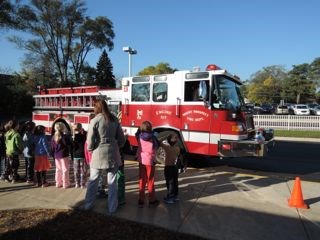 The fire department escorts Westbrook student Michael from Ms. Brewer’s first grade class to school.