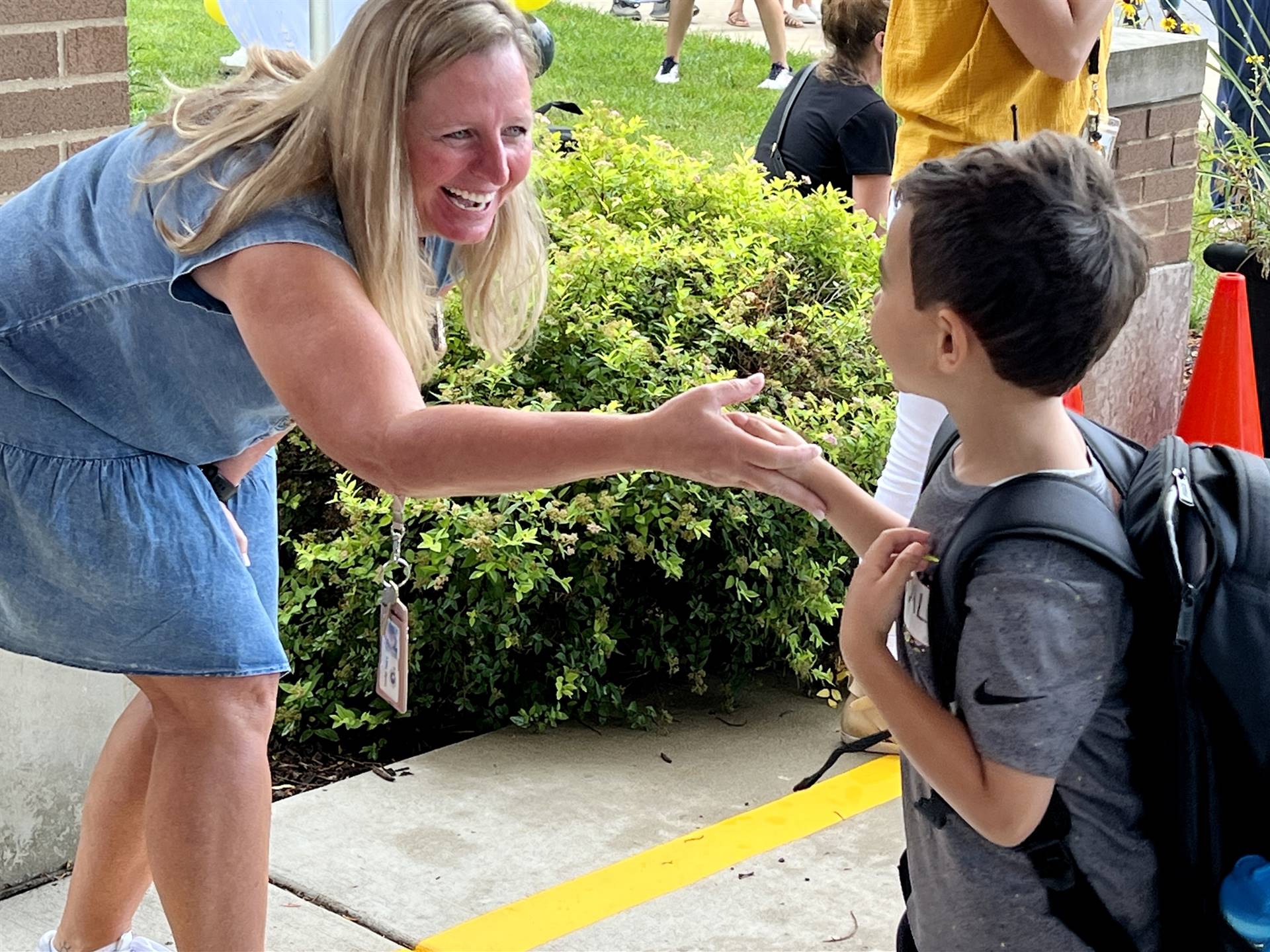 Weestbrook teacher welcoming a student